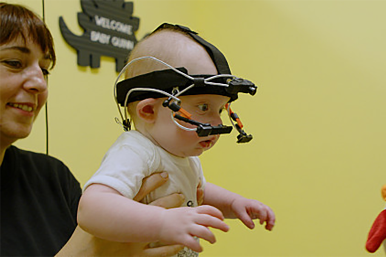 An infant wears a head-mounted camera to collect visual data on her point of view.