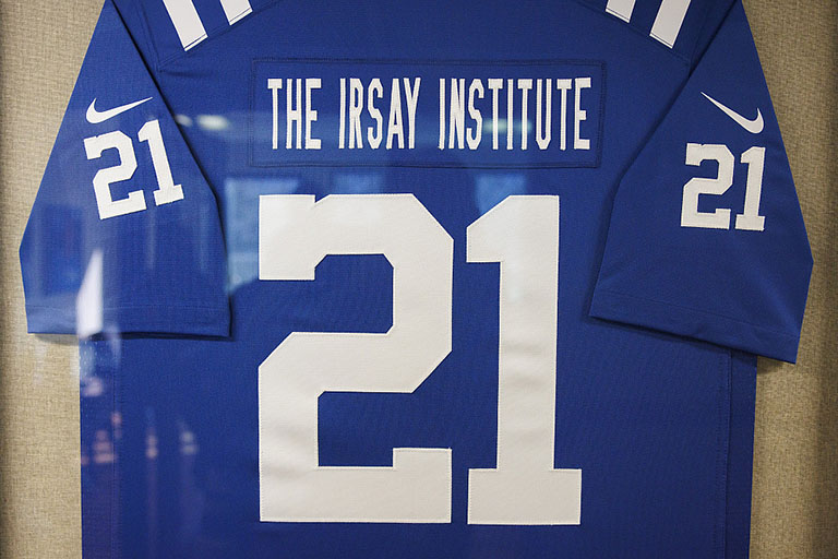 A football jersey with the number 21. The jersey says ‘The Irsay Institute’ across the top.