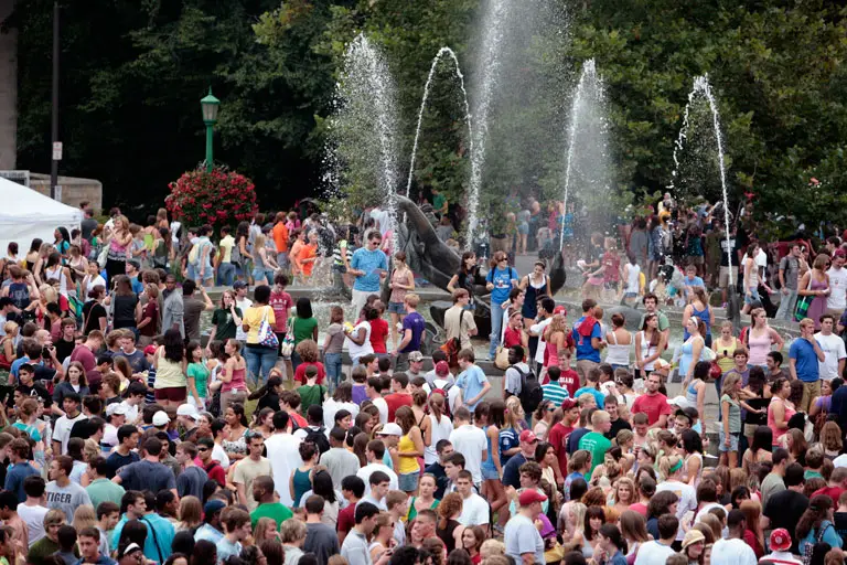 Large crowd of students around IU Auditorium fountain.