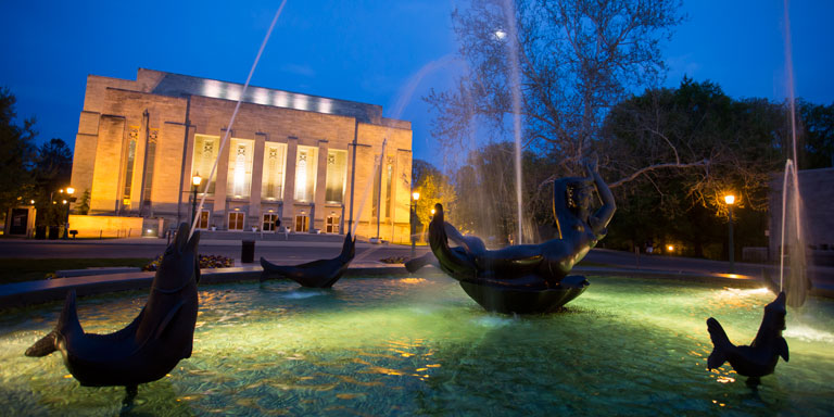 The IU Auditorium and Showalter Fountain at night